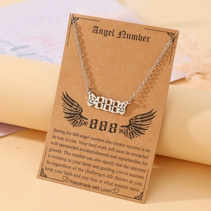 Macro detail of silver angel number 888 necklace with wings on display card