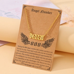 Macro view of gold angel number 888 necklace with wings on a kraft gift display card