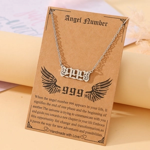 Silver angel number 999 necklace with butterfly wings on retro Kraft card display