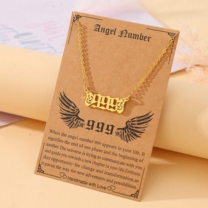 Golden 999 angel number necklace with butterfly wing pendant and meaning card