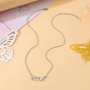 Detail shot of silver angel wing necklace with number 222 pendant and lobster clasp