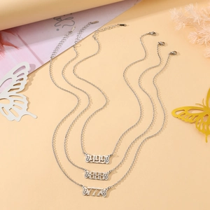 Detailed view of silver stainless steel necklaces with 777, 888, 999 angel number pendants