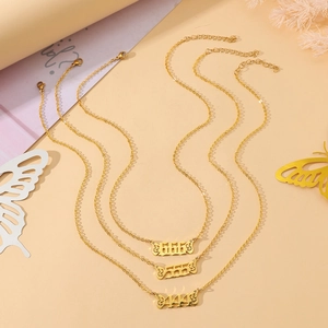 Detailed view of 444 555 666 angel number gold necklaces with butterfly wing charms