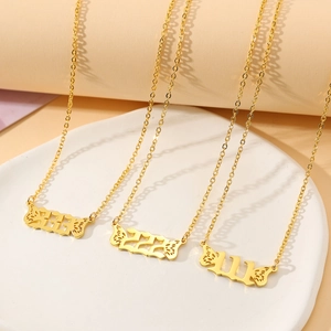 Detailed view of gold angel number necklaces with butterfly wings and hollow numbering