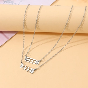 Detail of silver angel wing necklaces with Arabic numerals 333 and 444 pendants