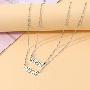 Detail of silver angel number necklaces 777 and 888 with creative wing pendants