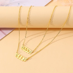Detail of gold butterfly wing angel number necklaces with 111 and 222 pendants