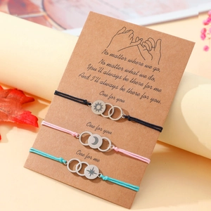 Three-piece set of sun moon and star bracelets on a gift card with a warm aesthetic