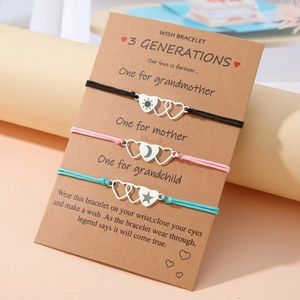 Detail of three generations heart bracelets with sun moon and star laser engraving