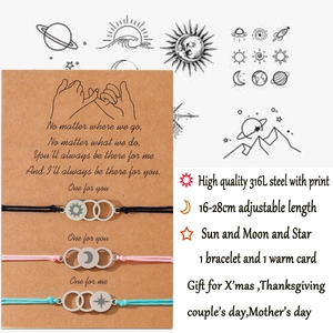 Adjustable sun moon and star woven bracelets set with stainless steel charms on a gift card