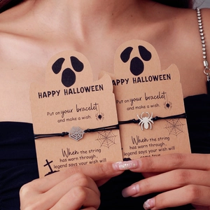Detail of Halloween hand-woven black rope bracelets with silver spider and web charms