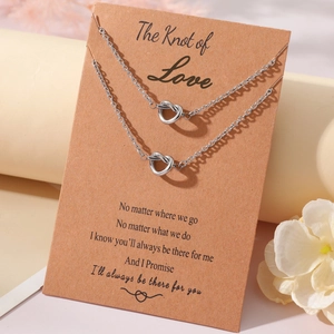 Silver love knot necklace set with display card on a minimalist elegant background