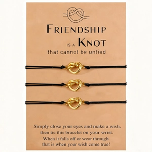Three-piece black friendship cord bracelets with golden heart charms on display card