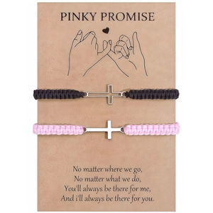 Close-up of woven couple bracelets with silver cross charms on a Pinky Promise card
