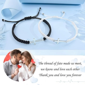 Detail of adjustable woven couple bracelets with silver cross charms in black and white