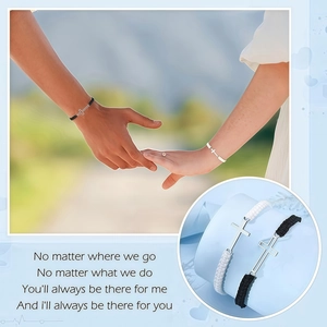 Detailed view of woven couple bracelets with polished metal crosses for men and women