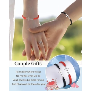 Detail of woven couple bracelets with silver cross charm and leaf ring in natural light