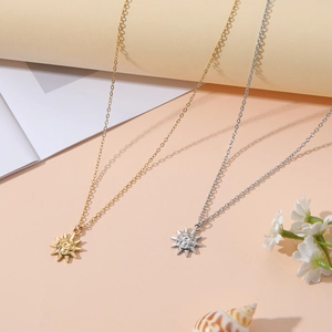 Detailaufnahme von Sonnenanhänger-Halsketten in Gold und Silber mit minimalistischer Kette