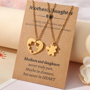 Détail de colliers cœur puzzle mère-fille sur une carte de message sentimentale