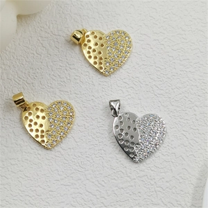 Macro detail of heart pendants with honeycomb cutout and pavé cubic zirconia