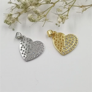 Golden and silver heart necklaces with zircons and hollow design on a white background