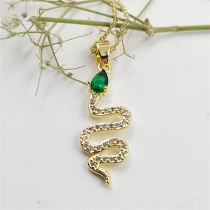 Elegant gold snake pendant necklace with green teardrop gemstone and sparkling zircons