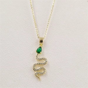 Detail of gold snake pendant with green water-drop zircon and sparkling crystals