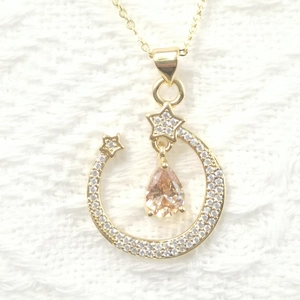 Elegant gold crescent moon and star necklace with champagne pear-shaped gemstone and zircons