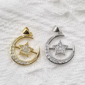 Sparkling moon and star pendants in gold and silver finish with zircon inlay on plush fabric