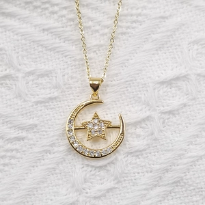 Elegant gold-plated star and moon pendant necklace with sparkling white zircon stones