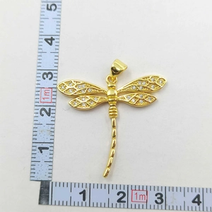 Detailed view of gold dragonfly pendant size measuring 3.5cm with white zircon wings