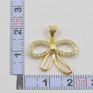 Detailed size measurement of a gold bow pendant with sparkling zircon and fringe details