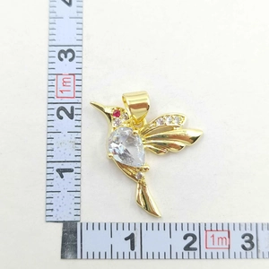 Detailed measurement of a hummingbird pendant with gold plating and clear zircons