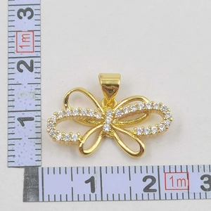 Bow pendant size measurement showing 2.5cm width with gold plating and white zircons