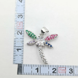 Detailed size measurement of a dragonfly pendant with multi-colored zirconia stones