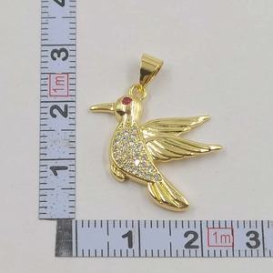 Detail view of a gold hummingbird pendant with crystals measuring 30mm x 25mm
