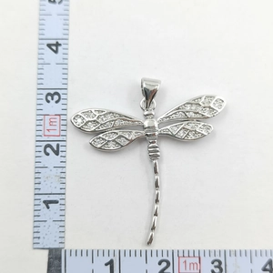 Detailed view of silver dragonfly pendant with micro-paved zircons and size measurements