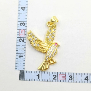 Detailed measurement of gold bird pendant with white zircons and red gemstone eye