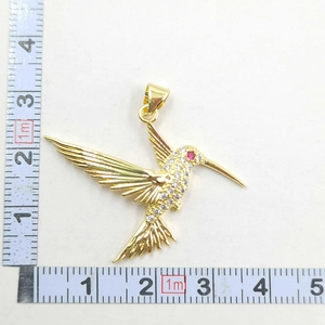 Detailed view showing dimensions of a hummingbird pendant with micro-pave crystals