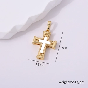 Macro shot of gold cross pendant with white enamel inlay and embossed texture detail