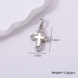 Macro detail of a vintage silver cross pendant with dimensions 1.8cm by 1.3cm