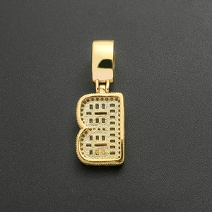 Detail of gold-plated letter B pendant with cubic zirconia and hollow grid back