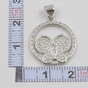 Close-up of a 2.5cm bow pendant with micro-pave crystals and silver finish