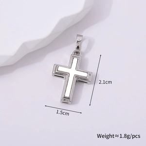 Detailed macro view of silver metal cross pendant with dimensions 2.1cm x 1.5cm