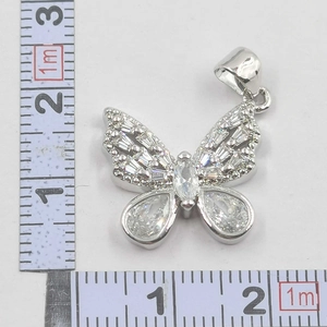 Bowtie pendant with cubic zirconia and silver plating measured at 21mm on scale