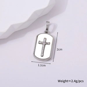 Macro shot of silver cross pendant showing dimensions 2cm by 1.1cm and 2.4g weight