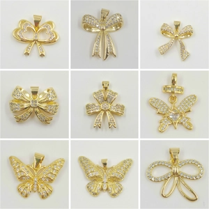 Nine gold bow and butterfly pendant charms set with sparkling zircon crystals