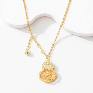 Detailed macro shot of a hollowed-out gold gourd pendant necklace with mesh texture