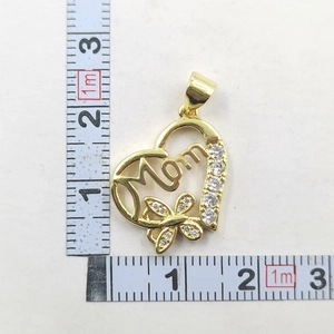 Detailed view of heart-shaped Mom pendant with butterfly and zircon stones on measuring tape