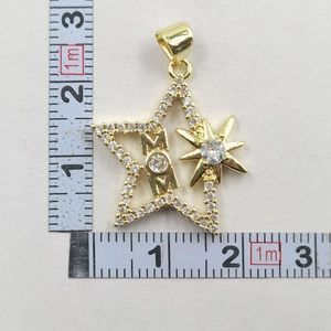 Detailed close-up of a gold star pendant with 'MOM' lettering and sparkling zircons